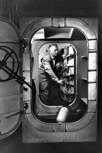 Dr. Hubertus Strughold, the first director of the U.S. Air Force School of Aviation Medicine’s Department of Space Medicine, examines the interior of a low pressure chamber that was converted into the world’s first space cabin simulator.