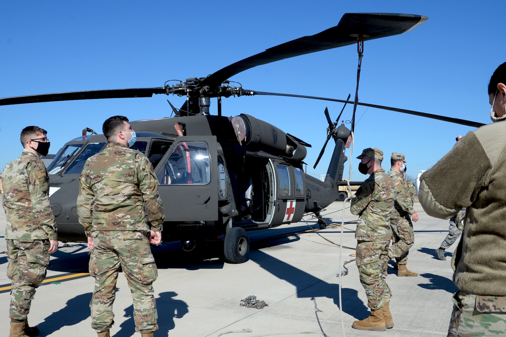 Operation Nightstorm ground crew members familiarize themselves with a UH-60 Black Hawk helicopter in preparation for sling loading cargo Dec. 14, 2020, at Martindale Army Air Field, San Antonio, Texas. (U.S. Air Force photo by Tech. Sgt. Samantha Mathison)
