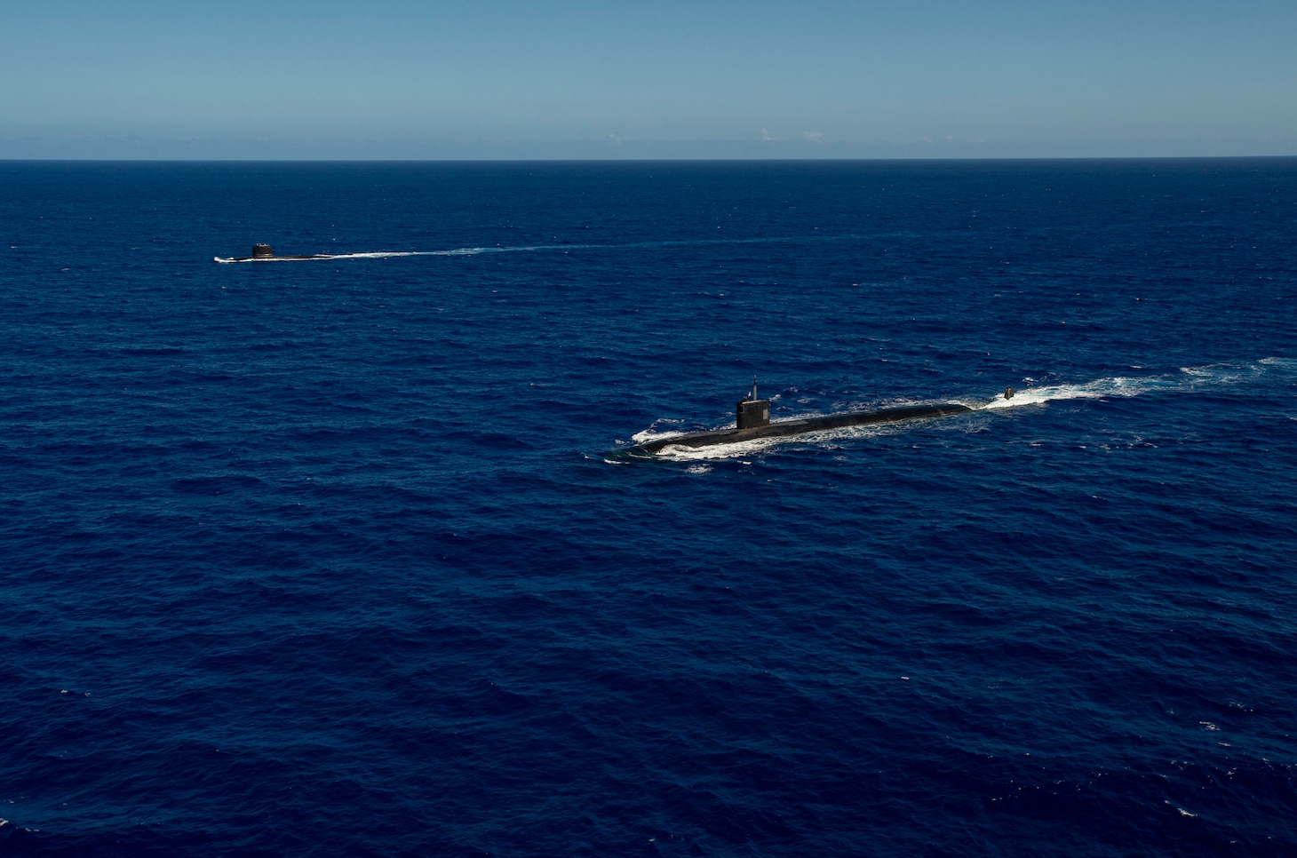 WATERS OFF GUAM (Dec. 11, 2020) The Los Angeles-class fast-attack submarine USS Asheville (SSN 758), right, and the French Navy Rubis-class nuclear powered submarine (SSN) Émeraude steam in formation off the coast of Guam during a photo exercise. Asheville and Émeraude practiced high-end maritime skills in a multitude of disciplines designed to enhance interoperability between maritime forces. Asheville is one of four forward-deployed submarines assigned to Commander, Submarine Squadron 15. (U.S. Navy photo by Mass Communication Specialist 2nd Class Kelsey J. Hockenberger)