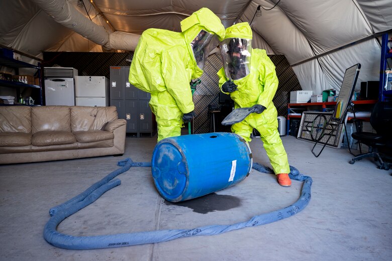 U.S. Airmen assigned to the 380th Expeditionary Civil Engineer Squadron emergency management flight cordon off a simulated spillage during a hazardous material (HAZMAT) exercise at Al Dhafra Air Base, United Arab Emirates, Dec. 18, 2020.