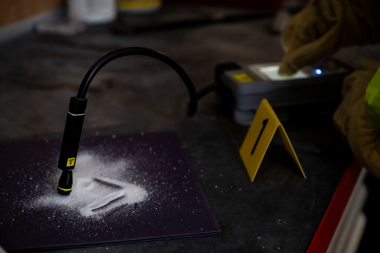 A simulated unknown substance is tested and collected during a hazardous material (HAZMAT) exercise at Al Dhafra Air Base, United Arab Emirates, Dec. 18, 2020.