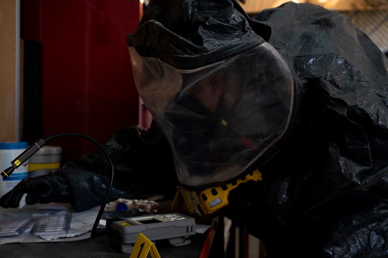 U.S. Air Force Staff Sgt. Jude Stueckle, 380th Expeditionary Civil Engineer Squadron (ECES) emergency management (EM) flight logistics technician, puts on a hazardous material (HAZMAT) uniform during a HAZMAT exercise at Al Dhafra Air Base, United Arab Emirates, Dec. 18, 2020.