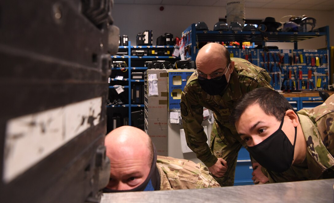 Tech. Sgt. Devin Dailey, 86th Aircraft Maintenance Squadron sortie support assistant flight chief, center, inspects a tool box at Ramstein Air Base, Germany, Dec. 21, 2020. Dailey earned Airlifter of the Week for his work in acquiring materials from the Defense Logistics Agency at zero cost to his unit, which improved efficiency. (U.S. Air Force photo by Senior Airman Thomas Karol)