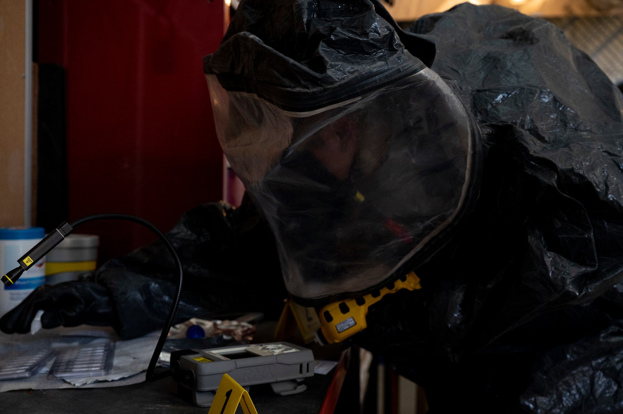 U.S. Air Force Staff Sgt. Jude Stueckle, 380th Expeditionary Civil Engineer Squadron (ECES) emergency management (EM) flight logistics technician, puts on a hazardous material (HAZMAT) uniform during a HAZMAT exercise at Al Dhafra Air Base, United Arab Emirates, Dec. 18, 2020.