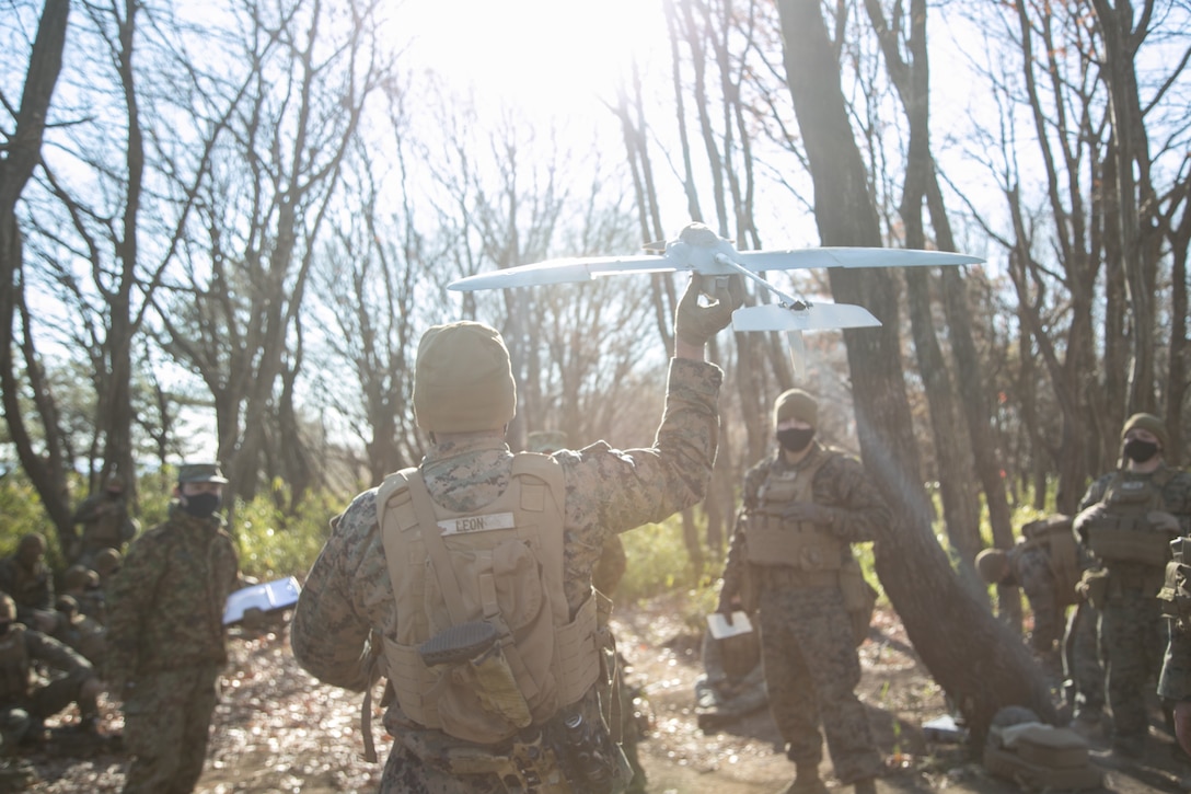 A U.S. Marine practices throwing a RQ-12 Wasp Small Unmanned Aerial System for an aerial ISR exchange during exercise Forest Light Eastern Army in mainland Japan, Dec. 16.