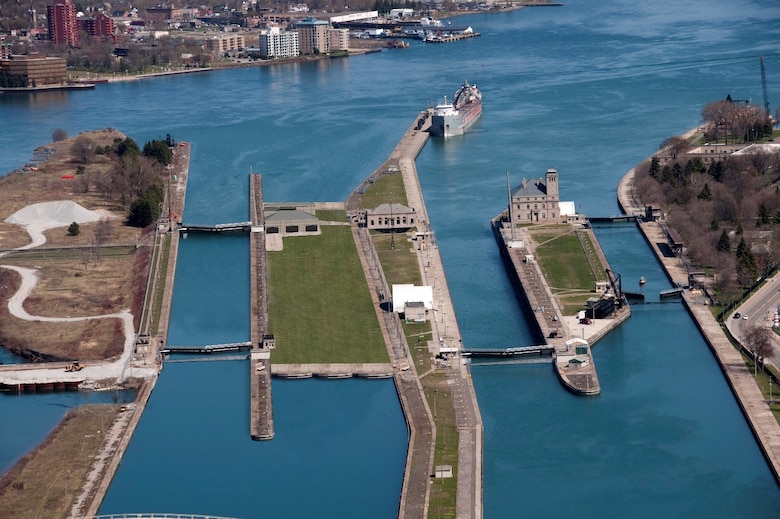 An artist rendering of the Soo Locks after constructing a second Poe-sized lock that will offer much needed resiliency in the Great Lakes Navigation System. The lock will match the Poe Lock, center, of 110-feet by 1,200-feet and built on the existing Davis and Sabin Locks sites. The Corps contractor wrapped up the first year of upstream channel deepening, excavating between two and six feet of Jacobsville sandstone to deepen it enough for the 1,000-foot ships that will use it.