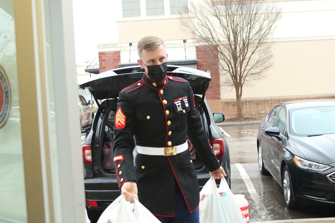 U.S. Marine Sgt. Joshua Roberson, a canvassing recruiter with Recruiting Substation Raleigh, Recruiting Station Raleigh brings Toys for Tots donations into the recruiting station in Raleigh, North Carolina, Dec. 16, 2020. The donations were received from Christina DiGiulio and her son Elijah, a 7-year-old boy, who have made donations to Toys for Tots for the past three years. (U.S. Marine Corps photo by Sgt Jacob Colvin)