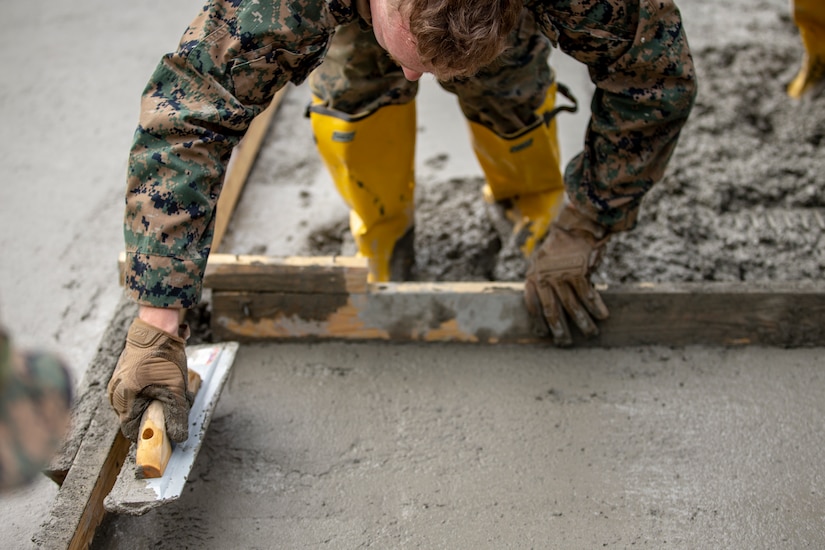 A Marine works on a construction site.