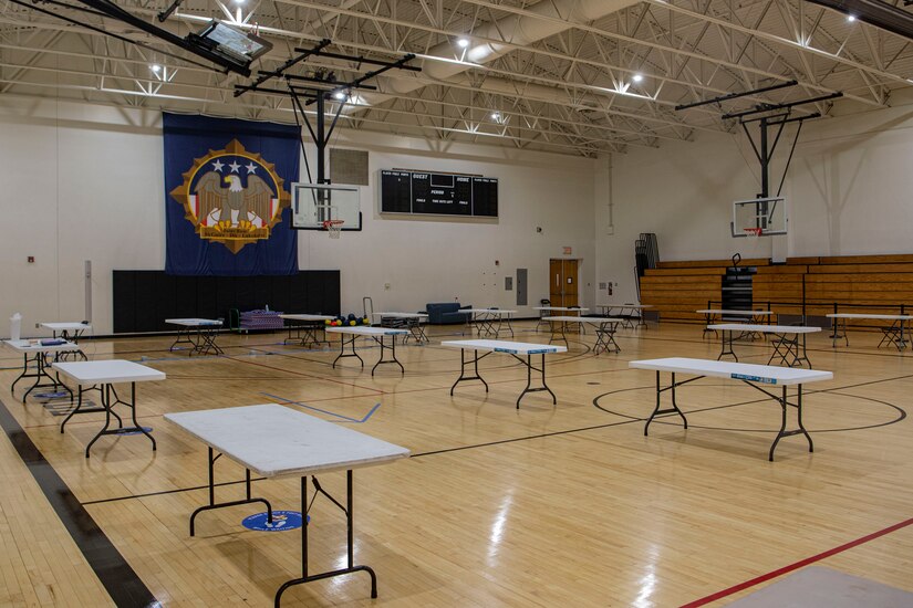 Photo of tables sitting in a gym.