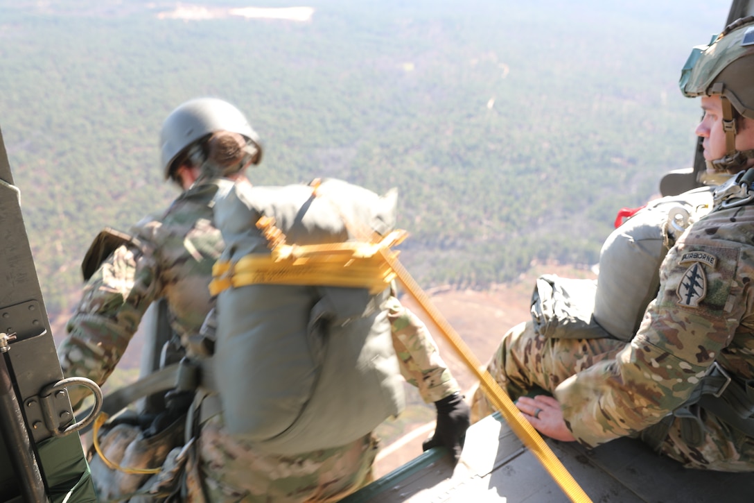 U.S. Army paratroopers jumping from a UH-60 Black Hawk at Sicily Drop Zone, Fort Bragg, N.C., Dec. 3, 2020, during non-tactical airborne operations hosted by the Army Reserve's U.S. Army Civil Affairs and Psychological Operations Command (Airborne) and the 82nd Airborne Division.