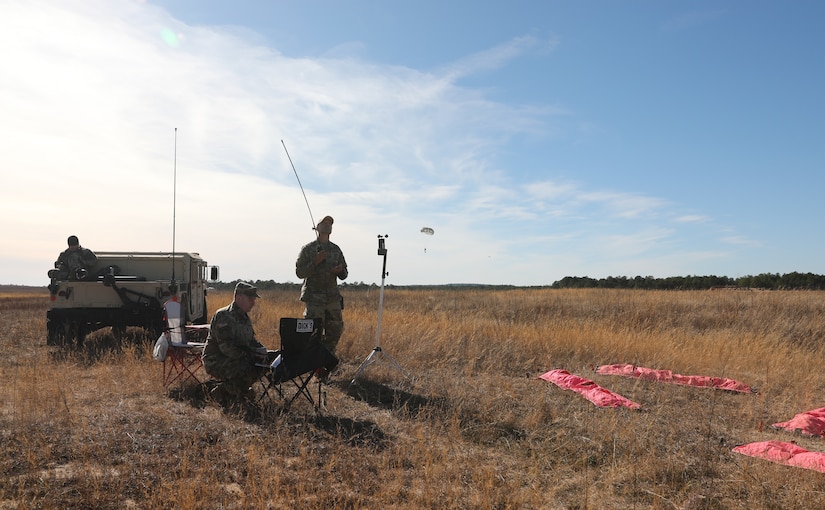 The Soldiers of the USACAPOC(A) drop zone detail monitor an airborne jump at Sicily Drop Zone, Fort Bragg, N.C., Dec. 3, 2020, during non-tactical airborne operations hosted by the Army Reserve's U.S. Army Civil Affairs and Psychological Operations Command (Airborne) and the 82nd Airborne Division.