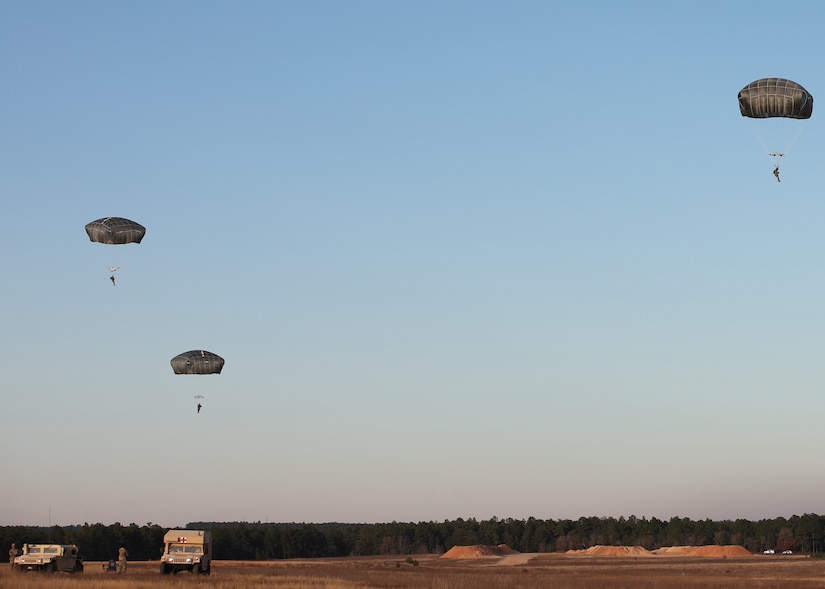 U.S. Army paratroopers jump from a UH-60 Black Hawk at Sicily Drop Zone, Fort Bragg, N.C., Dec. 3, 2020, during non-tactical airborne operations hosted by the U.S. Army Reserve's U.S. Army Civil Affairs and Psychological Operations Command (Airborne) and the 82nd Airborne Division.