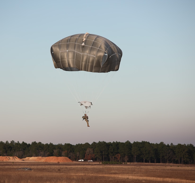 A U.S. Army paratrooper jumps from a UH-60 Black Hawk at Sicily Drop Zone, Fort Bragg, N.C., Dec. 3, 2020, during non-tactical airborne operations hosted by the U.S. Army Reserve's U.S. Army Civil Affairs and Psychological Operations Command (Airborne) and the 82nd Airborne Division.