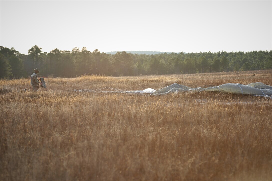 A U.S. Army paratrooper packs his parachute after a jump from UH-60 Black Hawk aircraft at Sicily Drop Zone at Fort Bragg, N.C., Dec. 3, 2020, during non-tactical airborne operations hosted by the U.S. Army Reserve's U.S. Army Civil Affairs and Psychological Operations Command (Airborne) and the 82nd Airborne Division.