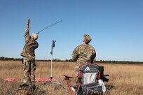The Soldiers of the USACAPOC(A) drop zone detail monitor an airborne jump at Sicily Drop Zone, Fort Bragg, N.C., Dec. 3, 2020, during non-tactical airborne operations hosted by the Army Reserve's U.S. Army Civil Affairs and Psychological Operations Command (Airborne) and the 82nd Airborne Division.