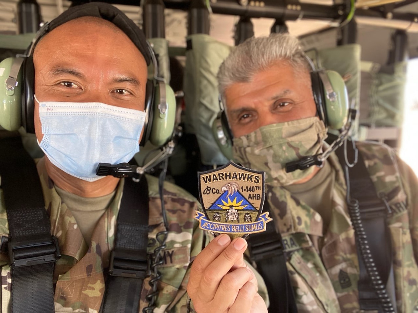 Two soldiers pose for a close-up photo together