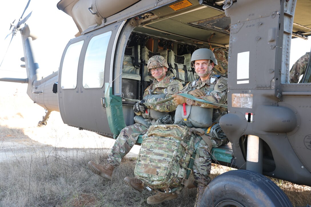 U.S. Army Reserve Brig. Gen. Michael M. Greer (left), U.S. Army Civil Affairs and Psychological Operations Command (Airborne) deputy commanding general, and Col. Thomas C. Akerlund (right), U.S. Army Civil Affairs and Psychological Operations Command (Airborne) G1, prepare to conduct airborne operations at Sicily Drop Zone, Fort Bragg, N.C., Dec. 3, 2020, during non-tactical airborne operations hosted by the U.S. Army Reserve's USACAPOC(A) and the 82nd Airborne Division.