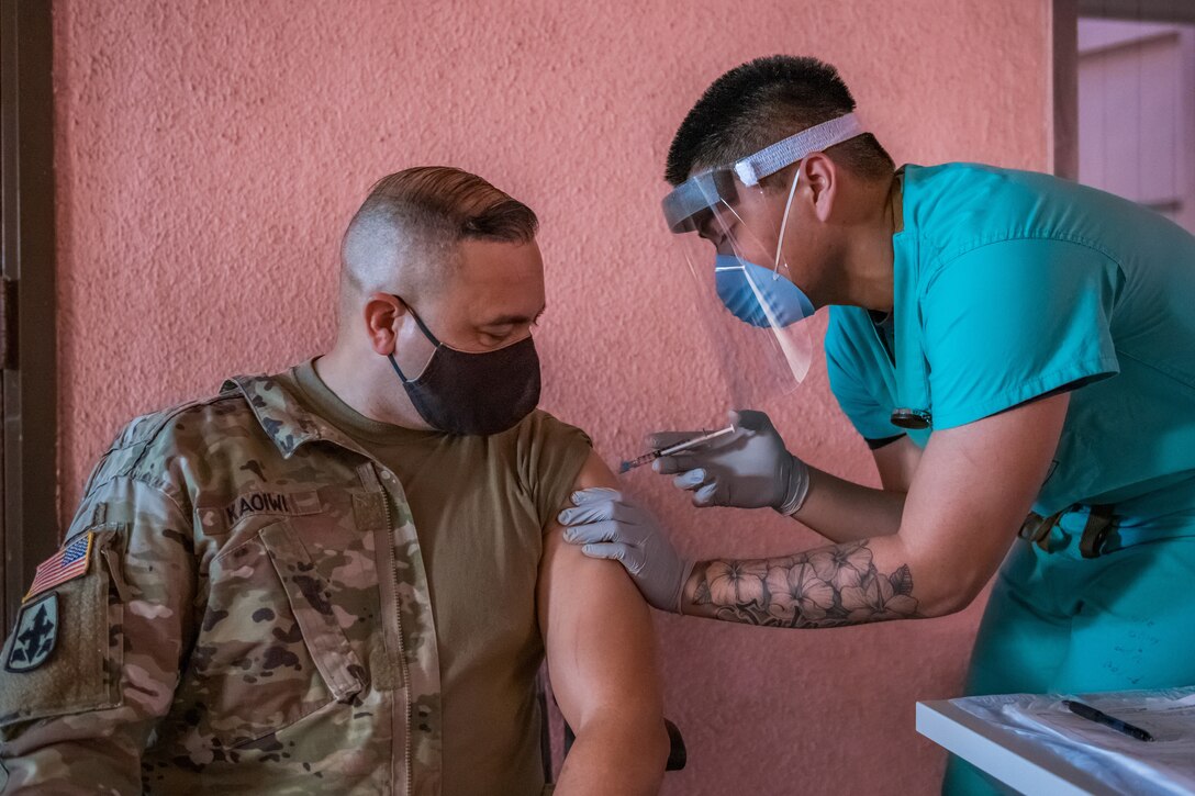 A soldier gets inoculated with the COVID-19 vaccine.
