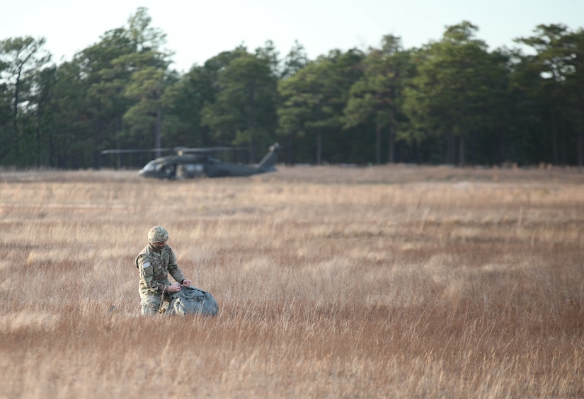 A U.S. Army paratrooper packs his parachute after a jump from UH-60 Black Hawk aircraft at Sicily Drop Zone at Fort Bragg, N.C., Dec. 3, 2020, during non-tactical airborne operations hosted by the U.S. Army Reserve's U.S. Army Civil Affairs and Psychological Operations Command (Airborne) and the 82nd Airborne Division.