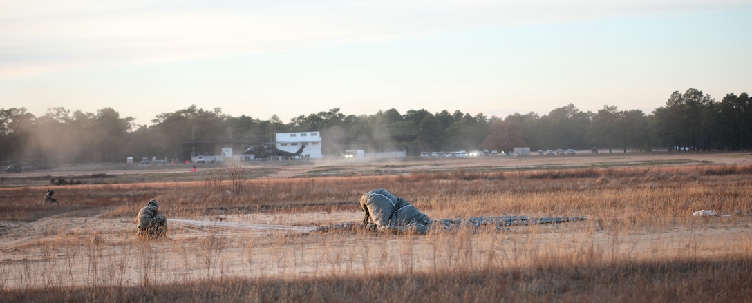 A U.S. Army paratrooper packs his parachute after a jump from UH-60 Black Hawk aircraft at Sicily Drop Zone at Fort Bragg, N.C., Dec. 3, 2020, during non-tactical airborne operations hosted by the U.S. Army Reserve's U.S. Army Civil Affairs and Psychological Operations Command (Airborne) and the 82nd Airborne Division.