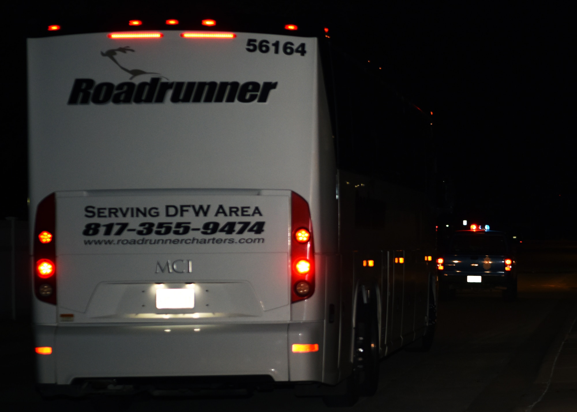 A 17th Security Forces Squadron truck escorts busses off base during Exodus at the Mathis Fitness Center on Goodfellow Air Force Base, Texas, Dec. 23, 2020. All busses were searched before entering Goodfellow  and escorted off base to ensure the safety of all personnel. (U.S. Air Force photo by Airman 1st Class Ethan Sherwood)