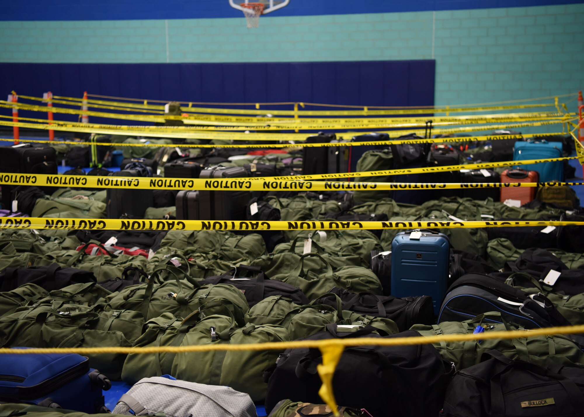 Students’ bags wait in rows to be picked up before boarding busses during Exodus at the Mathis Fitness Center on Goodfellow Air Force Base, Texas, Dec. 22, 2020. Bags were separated by bus to make the process as efficient as possible. (U.S. Air Force photo by Airman 1st Class Ethan Sherwood)