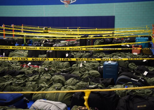 Students’ bags wait in rows to be picked up before boarding busses during Exodus at the Mathis Fitness Center on Goodfellow Air Force Base, Texas, Dec. 22, 2020. Bags were separated by bus to make the process as efficient as possible. (U.S. Air Force photo by Airman 1st Class Ethan Sherwood)