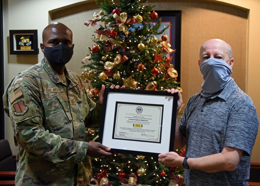 U.S. Air Force Col. James Finlayson, 17th Training Wing vice commander, is presented a Certificate of Appreciation by Retired Chief Master Sgt. JJ Graham, on behalf of the All Veterans Council of Tom Green County at the Norma Brown Building on Goodfellow Air Force Base, Texas, Dec. 23, 2020. Finlayson's contribution and dedication to the Veterans Day Parade earned him the recognition of local veterans. (U.S. Air Force photo by Airman 1st Class Ethan Sherwood)