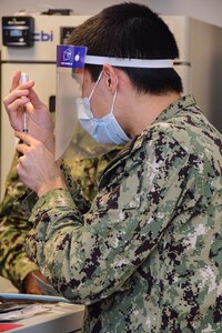 Hospitalman Roman Silvestri prepares a dosage of the COVID-19 vaccination for administration. Naval Medical Center Portsmouth’s (NMCP) Immunizations department started administering the COVID-19 vaccine to NMCP staff members, Dec. 15.
