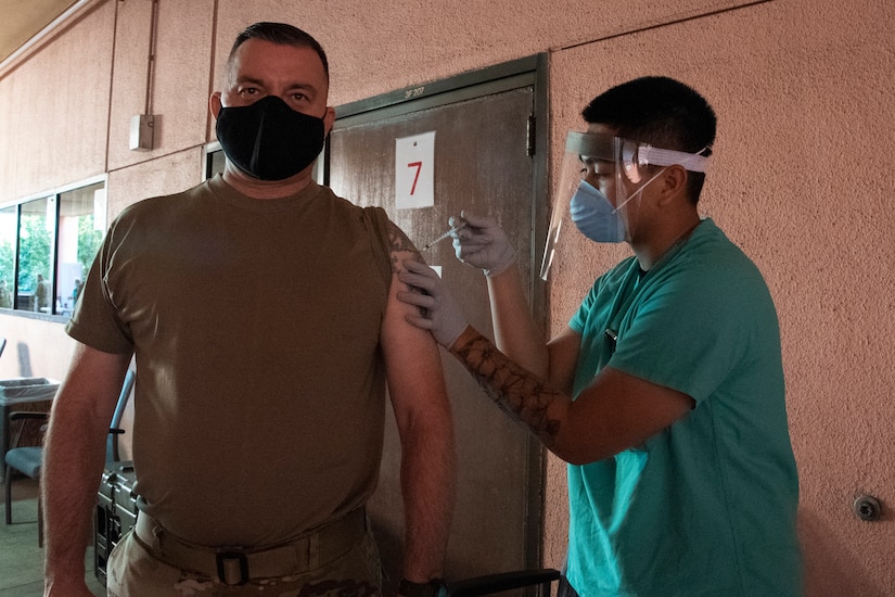 Sergeant Maj. Danny Hailey, sergeant major of Public Health Command-Pacific, receives the Pfizer vaccine at Tripler Army Medical Center, Honolulu, on Dec. 23, 2020. The inoculation was part of the Department of Defense COVID-19 vaccine distribution and administration plan that is a phased, standardized and coordinated strategy for prioritizing, distributing, and administering COVID-19 vaccines to protect DoD personnel, maintain readiness, and support the national COVID-19 response. (U.S. Army photo by Amber E. Kurka)