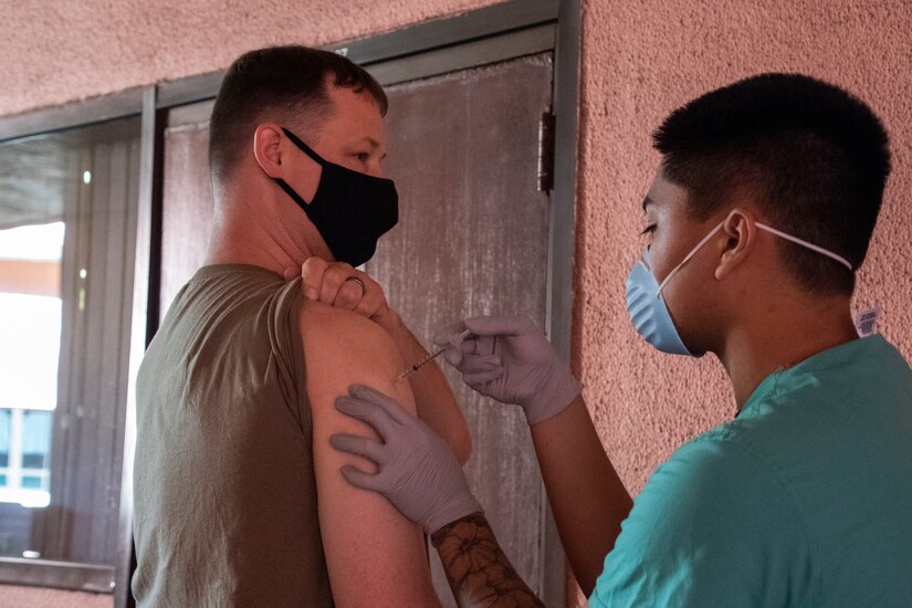 Sgt. 1st Class Michael Callison, Public Health Command-Pacific Operations NCO, receives the Pfizer vaccine at Tripler Army Medical Center, Honolulu, on Dec. 23, 2020. The inoculation was part of the Department of Defense COVID-19 vaccine distribution and administration plan that is a phased, standardized and coordinated strategy for prioritizing, distributing, and administering COVID-19 vaccines to protect DoD personnel, maintain readiness, and support the national COVID-19 response. (U.S. Army photo by Amber E. Kurka)