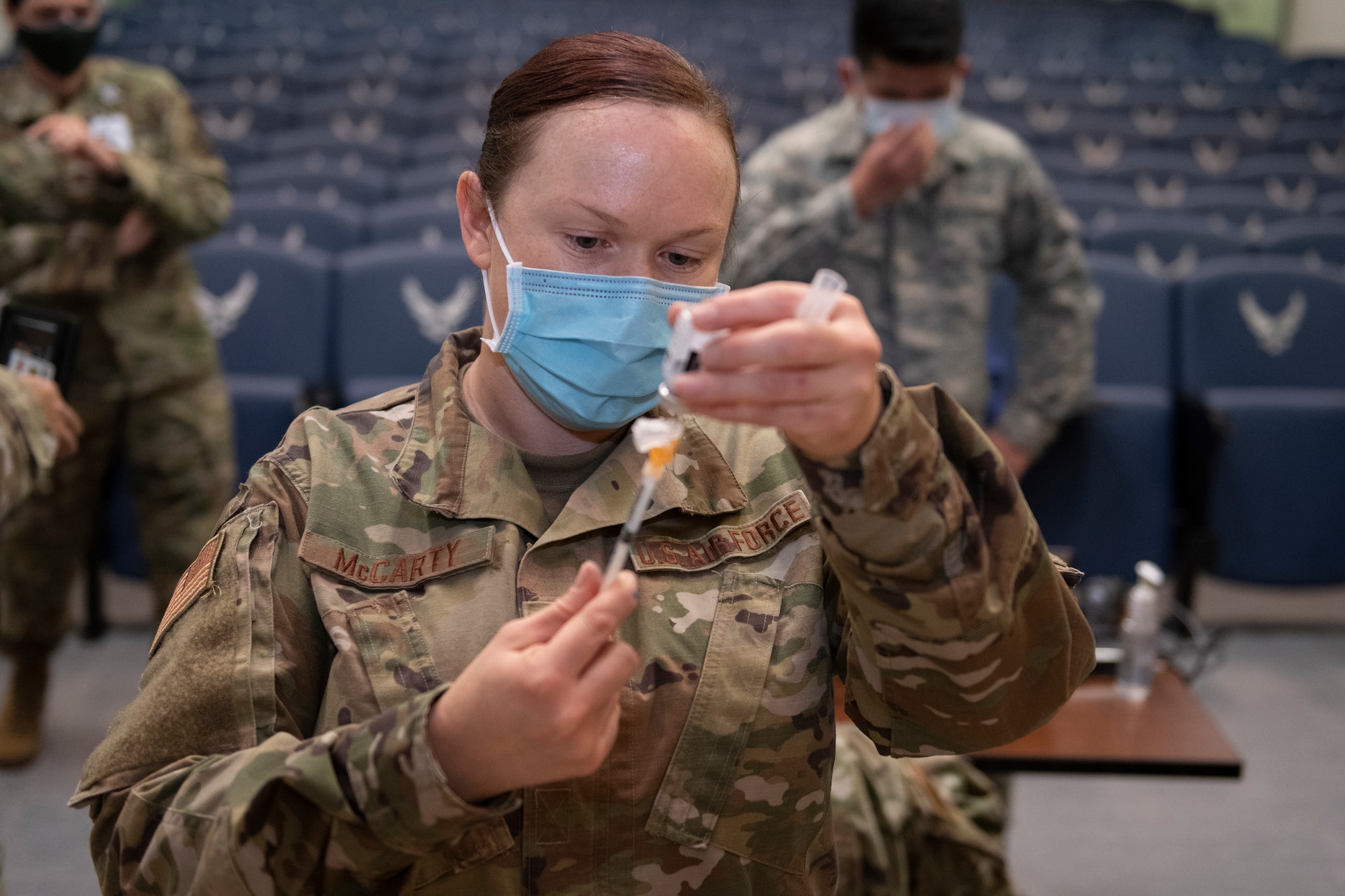 U.S. Air Force Tech. Sgt. Lori McCarty, 60th Healthcare Operations Squadron allergy immunization technician, fills an injection needle with the COVID-19 vaccine Dec. 22, 2020, at Travis Air Force Base, California. David Grant U.S. Air Force Medical Center is the largest Air Force medical facility and provides care to more than 276,000 Department of Defense and Veteran Affairs eligible beneficiaries. Essential medical personnel from the 60th Medical Group were the first to receive the vaccine at Travis AFB. (U.S. Air Force photo by Senior Airman Cameron Otte)