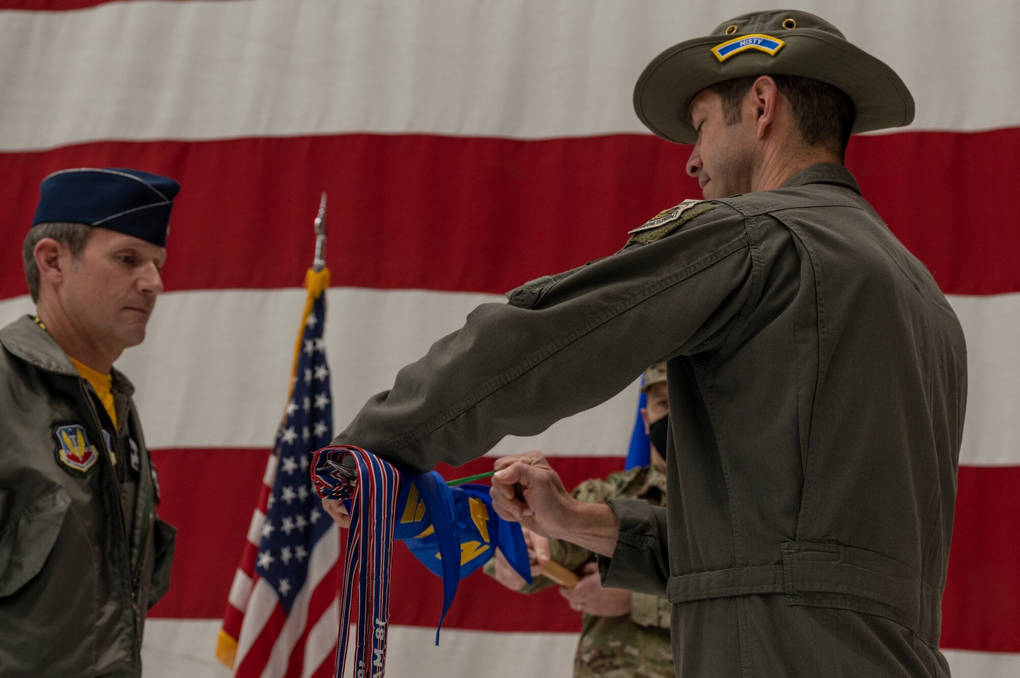 Person unfurls flag.