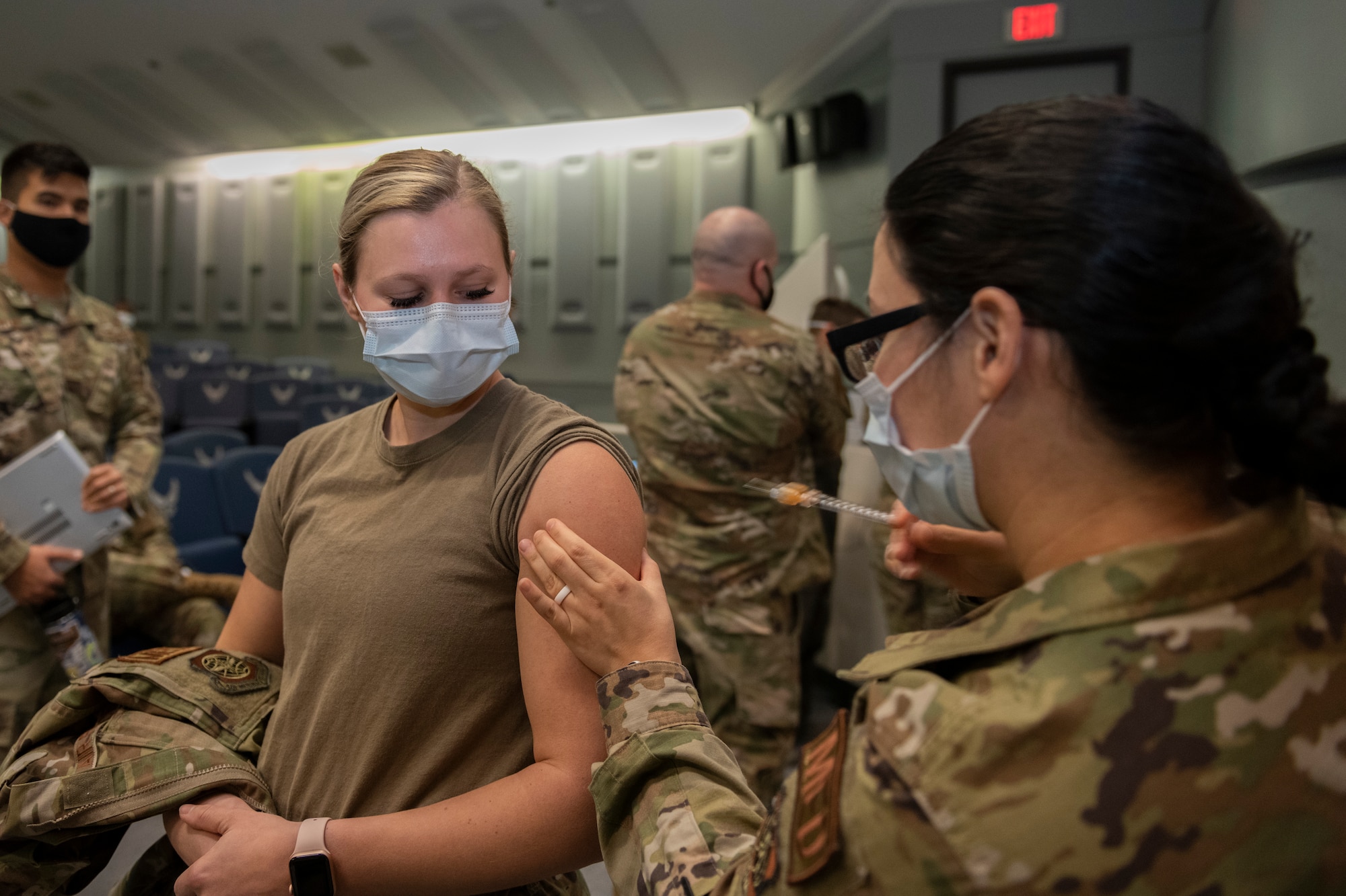U.S. Air Force 1st Lt. Fanny Perez, 60th Inpatient Squadron intensive care unit nurse, injects 1st Lt. Shelby Hannigan, 60th Inpatient Squadron critical care nurse, with the COVID-19 vaccine Dec. 22, 2020, at Travis Air Force Base, California. Perez was among the first Airmen at Travis AFB to receive the vaccine. Members of the 60th Medical Group were tasked to support local hospitals in Southern California and assist with pandemic relief efforts. David Grant U.S. Air Force Medical Center is the largest Air Force medical facility and provides care to more than 276,000 Department of Defense and Veteran Affairs eligible beneficiaries. Essential medical personnel from the 60th Medical Group were the first to receive the vaccine at Travis AFB. (U.S. Air Force photo by Senior Airman Cameron Otte)