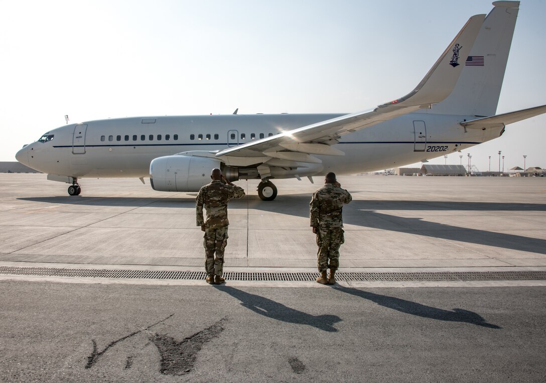 airmen salute a plane