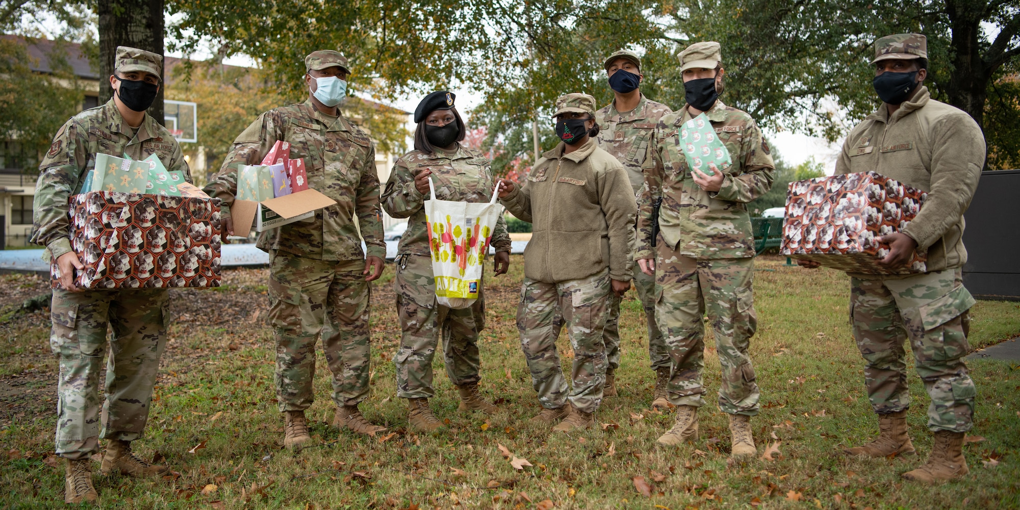 A team of master sergeants pose at the enlisted dormitories after delivering cookies to Airmen Dec. 16, 2020, on Maxwell Air Force Base, Alabama. The team wore masks and delivered the cookies in packaging to reduce the risks of COVID-19 transmission and to maintain safety.