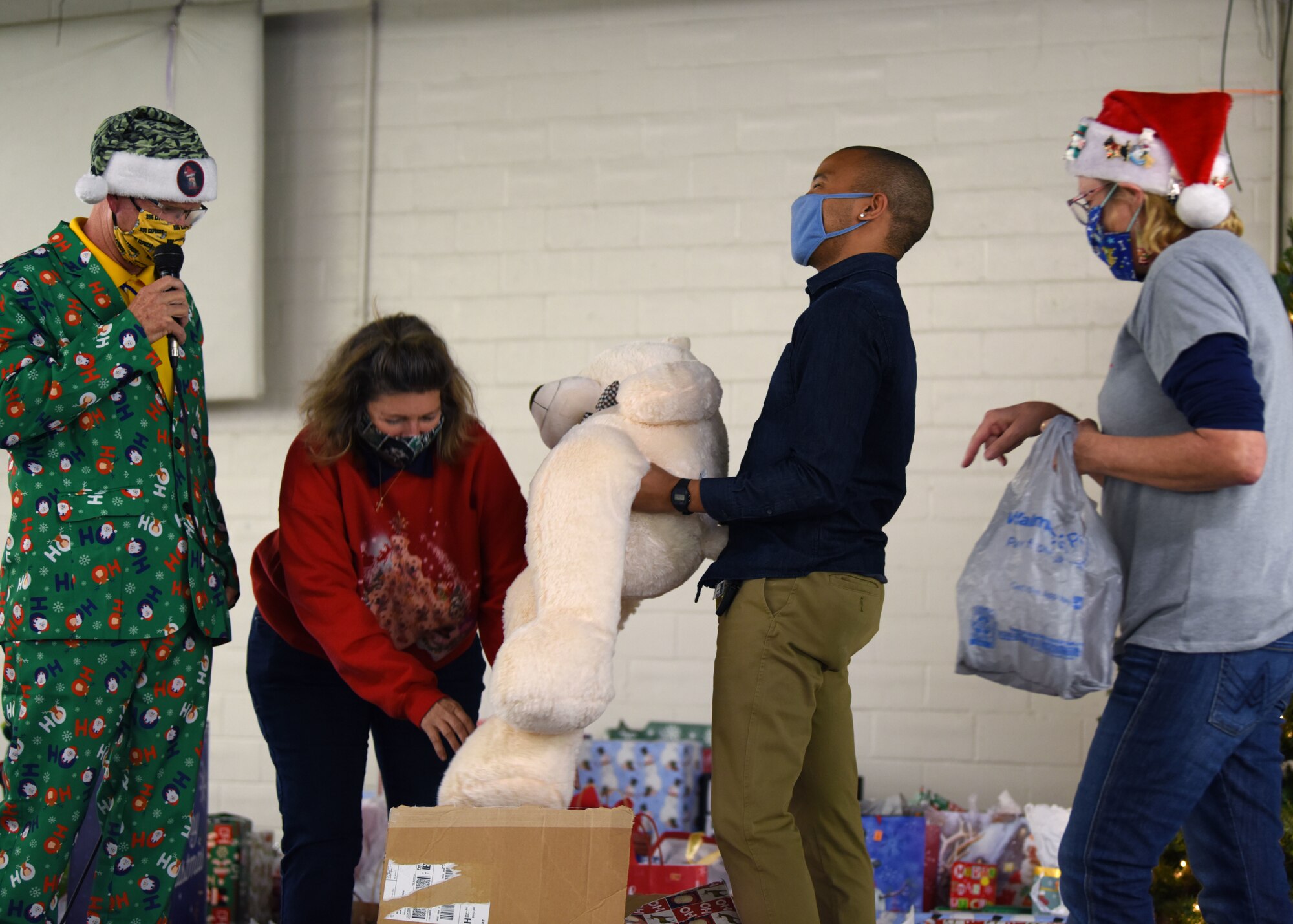 A Goodfellow student pulls a stuffed bear from a box at the Home Away From Home event in the First Financial Pavilion in San Angelo, Texas, Dec. 25, 2020. Each member left with several gifts to take back to the base. (U.S. Air Force photo by Airman 1st Class Ethan Sherwood)