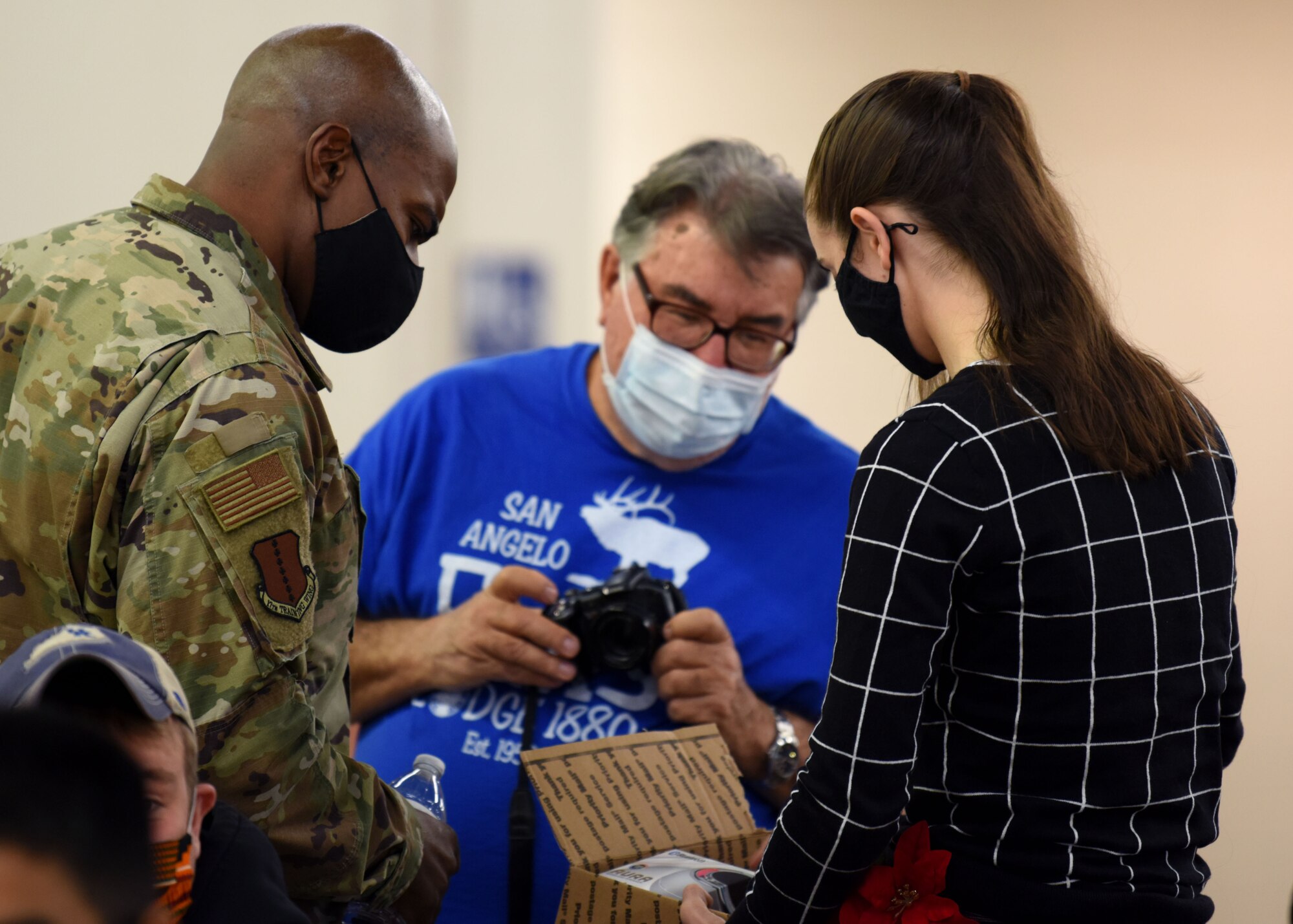 U.S. Air Force Col. James Finlayson, 17th Training Wing vice commander, inspects a gift given by the Elks Lodge at the Home Away From Home event in the First Financial Pavilion in San Angelo, Texas, Dec. 25, 2020. Goodfellow Air Force Base leadership interacted with students, checking in on them and wishing them happy holidays. (U.S. Air Force photo by Airman 1st Class Ethan Sherwood)