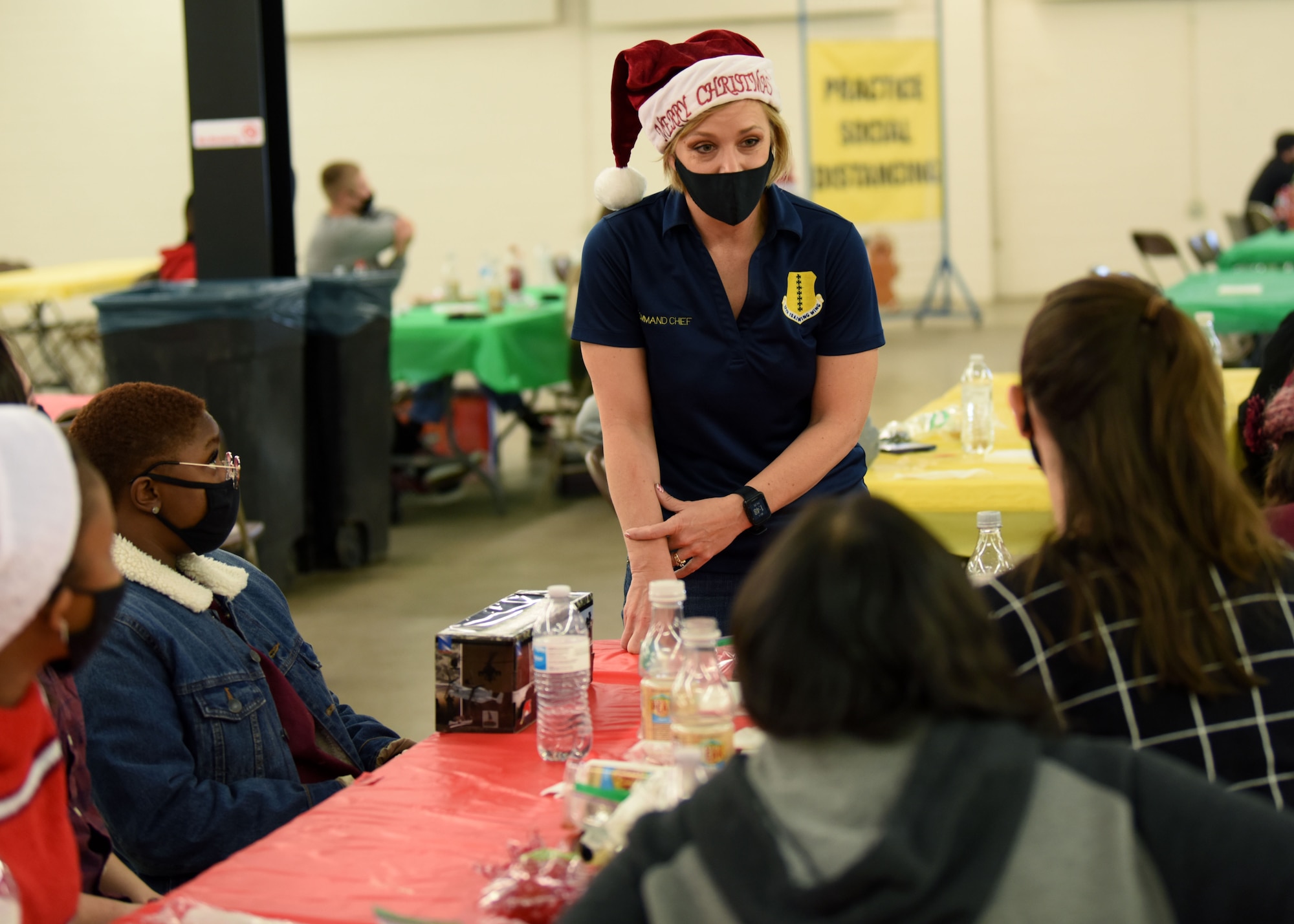 U.S. Air Force Chief Master Sgt. Casy Boomershine, 17th Training Wing command chief, converses with a table of Airmen during the Home Away From Home event in the First Financial Pavilion in San Angelo, Texas, Dec. 25, 2020. Boomershine checked in with the Airmen and wished them a happy holiday. (U.S. Air Force photo by Airman 1st Class Ethan Sherwood)