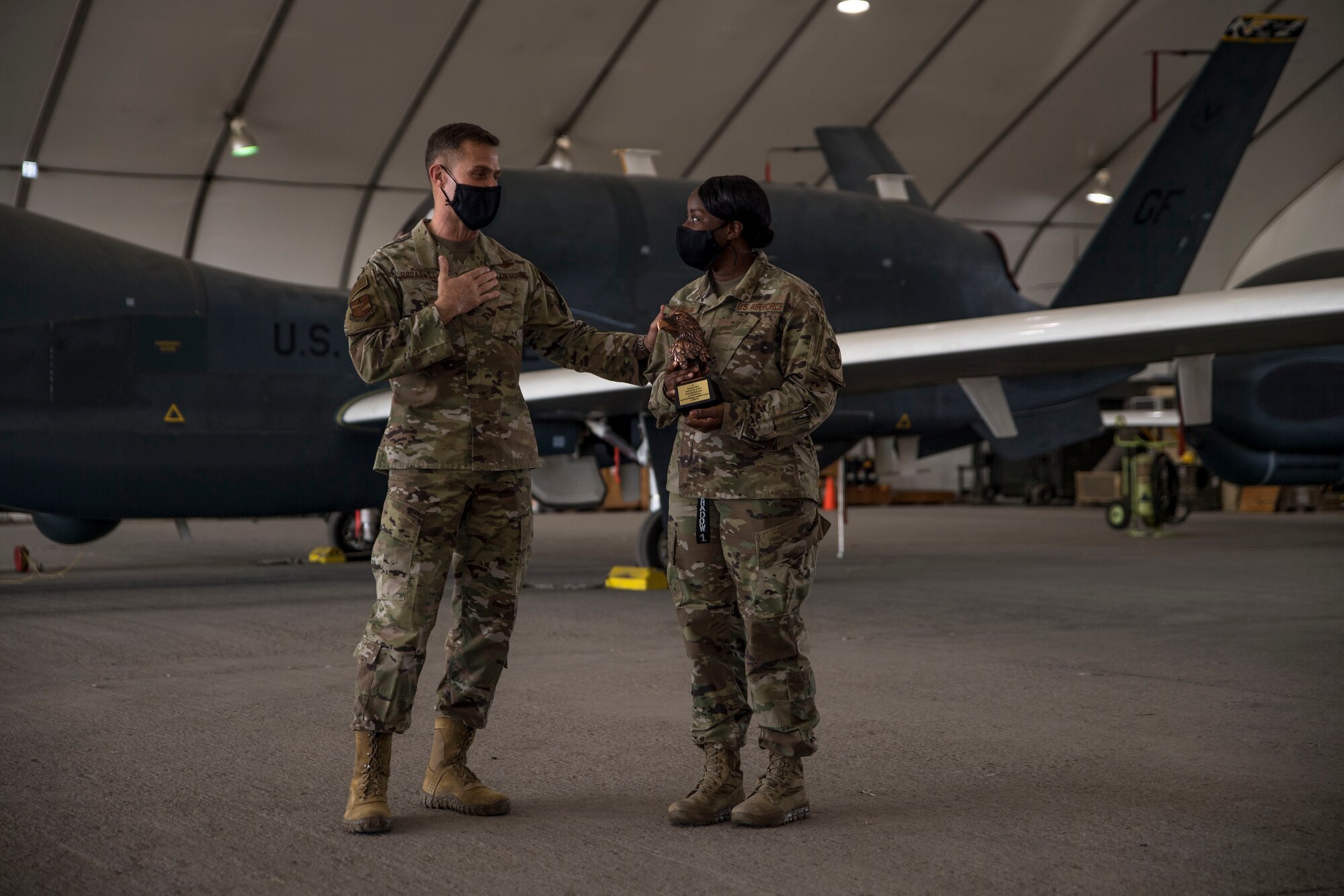 U.S. Air Force Brig. Gen. Larry Broadwell, 380th Air Expeditionary Wing commander, congratulates 1st Lt. Teirra Franklin, 380th Expeditionary Aircraft Maintenance Squadron, HAWK Aircraft Maintenance Unit officer in charge, after presenting her the Air Combat Command level General Lew Allen, Jr. Award at Al Dhafra Air Base, United Arab Emirates, Dec. 24, 2020.