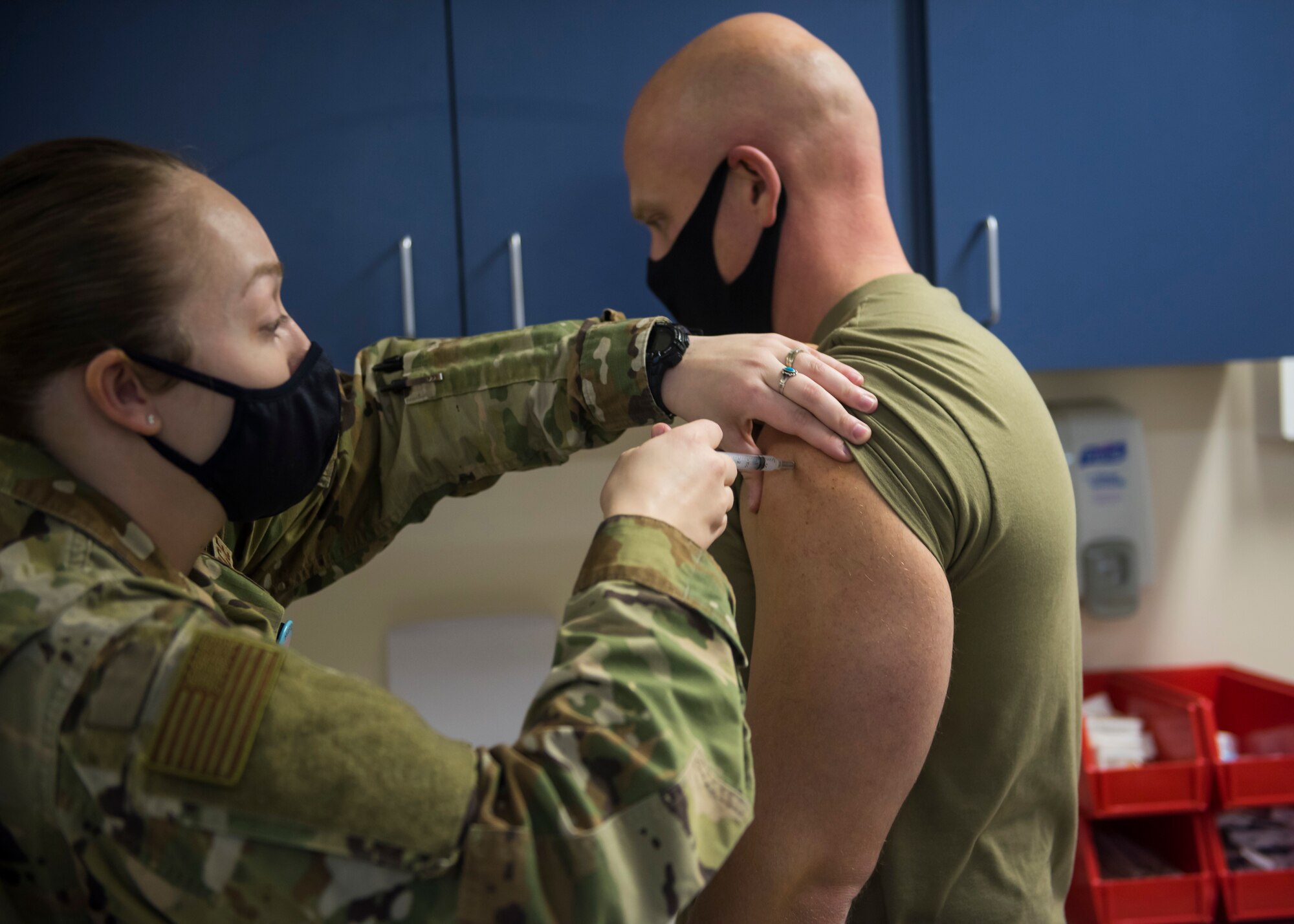 U.S. Air Force Tech. Sgt. Katelynn Hecht, 35th Surgical Operations Squadron Primary Care Flight chief, gives Chief Master Sgt. Joey R. Meininger, 35th Fighter Wing command chief, a dose of the COVID-19 vaccine at Misawa Air Base, Japan, Dec. 28, 2020. As manufacturing rates, Centers for Disease Control and Prevention allocation, and Department of Defense process validation permits, the DoD will increase distribution and administration to DoD facilities across the globe. (U.S. Air Force photo by Airman 1st Class Leon Redfern)