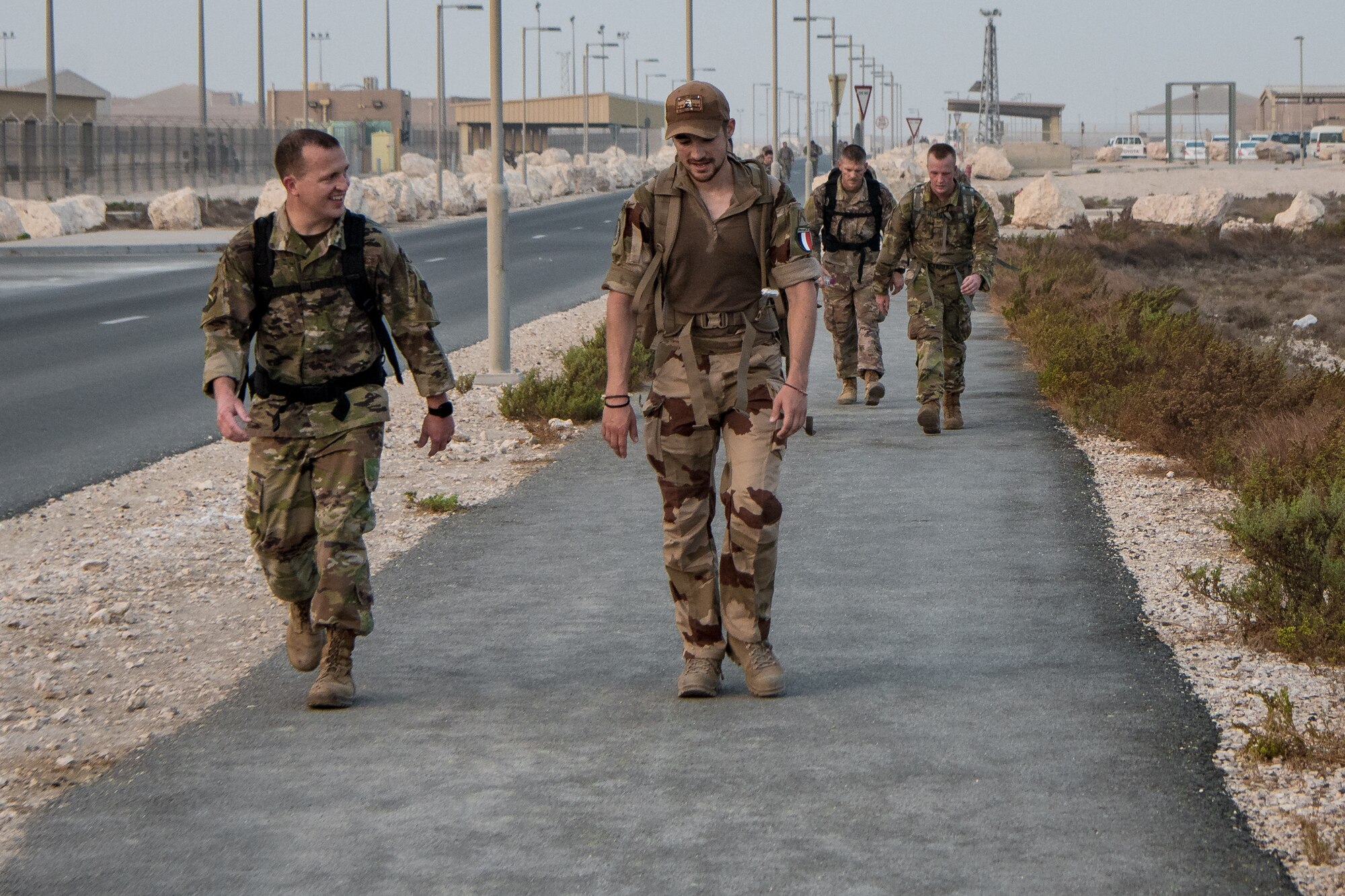men walk down road
