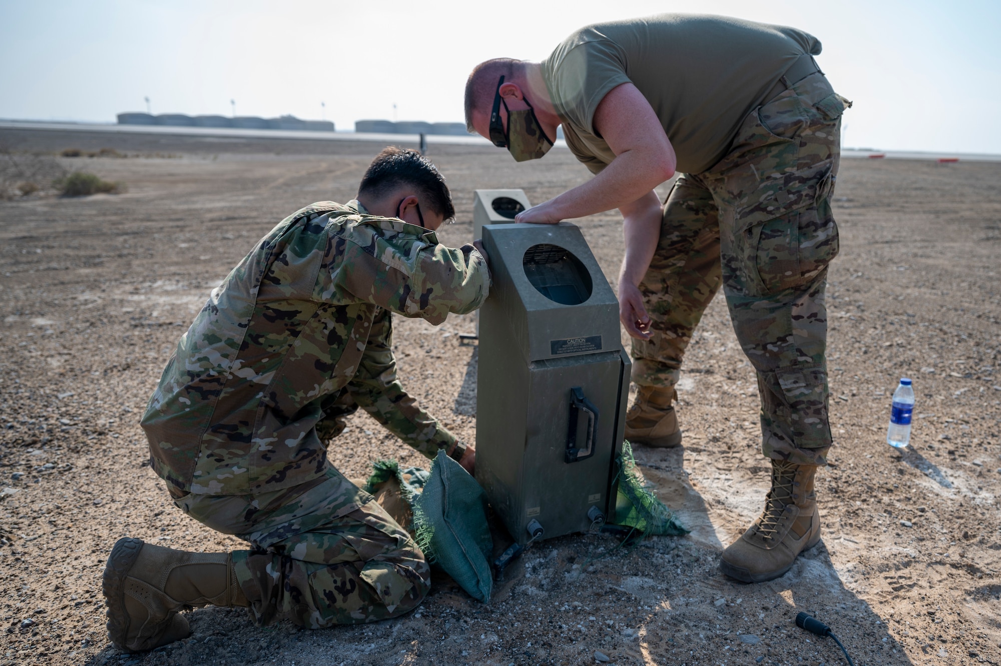 U.S. Air Force Master Sgt. Adam Garrison (left), 380th Expeditionary Operations Support Squadron weather flight chief, and U.S. Air Force Senior Airman Ricardo Solis-Arroyo (right), 380th Expeditionary Operations Support Squadron weather forecaster, install a newer weather system during an equipment pack up at Al Dhafra Air Base, United Arab Emirates, Dec. 23, 2020.