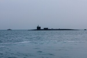 201227-A-RX269-1159 GULF OF BAHRAIN (Dec. 27, 2020) The guided-missile submarine USS Georgia (SSGN 729) transits the Gulf of Bahrain, outbound from a sustainment and logistics visit in Manama, Bahrain, Dec. 27. Georgia is deployed to the U.S. 5th Fleet area of operations in support of naval operations to ensure maritime stability and security in the Central Region, connecting the Mediterranean and Pacific through the Western Indian Ocean and three critical chokepoints to the free flow of global commerce.