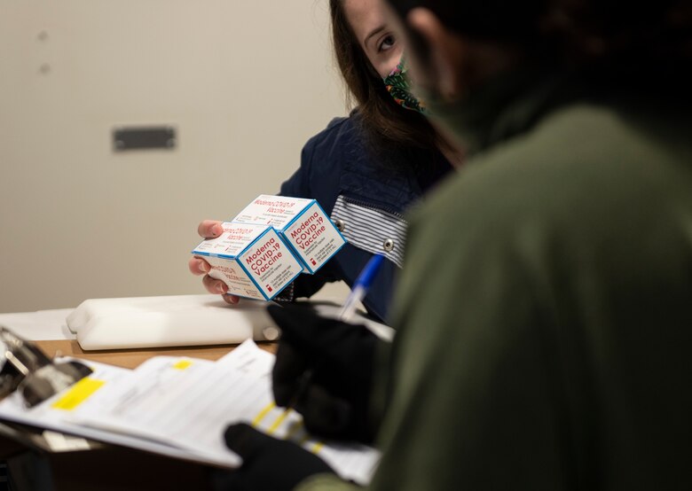 Airmen assigned to the 48th Medical Group record information from the first boxes of COVID-19 vaccinations delivered to Royal Air Force Lakenheath, England, Dec. 27, 2020. 48th FW personnel will be prioritized to receive the vaccine based on the guidance from the Centers for Disease Control and Prevention and on the DoD COVID Task Force’s assessment of unique DoD mission requirements. (U.S. Air Force photo by Airman 1st Class Jessi Monte)