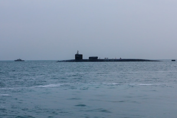 201227-A-RX269-1159 GULF OF BAHRAIN (Dec. 27, 2020) The guided-missile submarine USS Georgia (SSGN 729) transits the Gulf of Bahrain, outbound from a sustainment and logistics visit in Manama, Bahrain, Dec. 27. Georgia is deployed to the U.S. 5th Fleet area of operations in support of naval operations to ensure maritime stability and security in the Central Region, connecting the Mediterranean and Pacific through the Western Indian Ocean and three critical chokepoints to the free flow of global commerce.