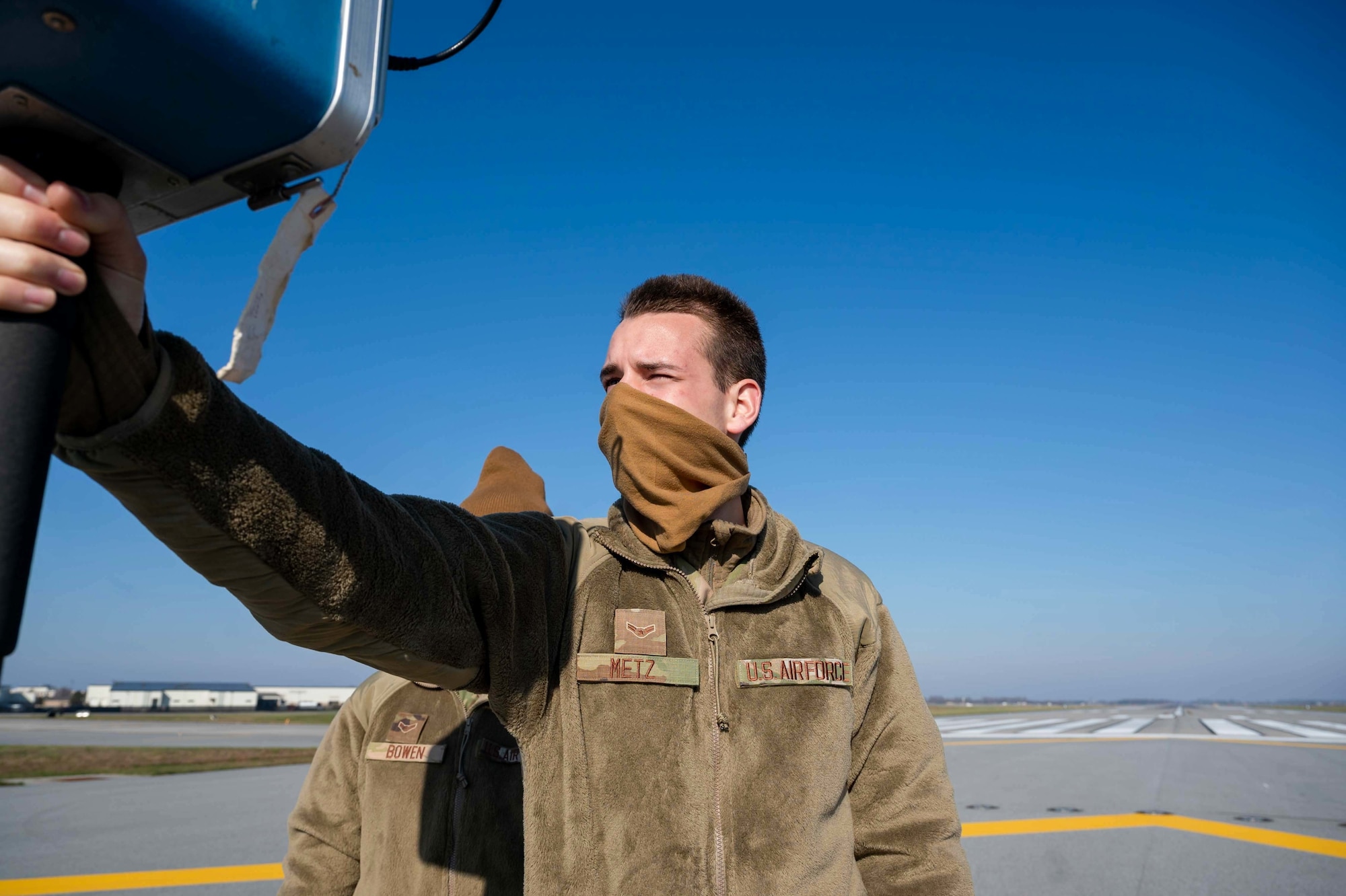 Airman 1st Class Albert Metz, 436th Operation Support Squadron Radar, Airfield and Weather Systems technician, uses a portable Instrument Landing System, at Dover Air Force Base, Delaware, Dec. 11, 2020. The newly installed ILS is one of five of its kind in the Air Force and the only one of its kind in Air Mobility Command. Dover is serving as a test base for this new system. (U.S. Air Force photo by Airman 1st Class Faith Schaefer)