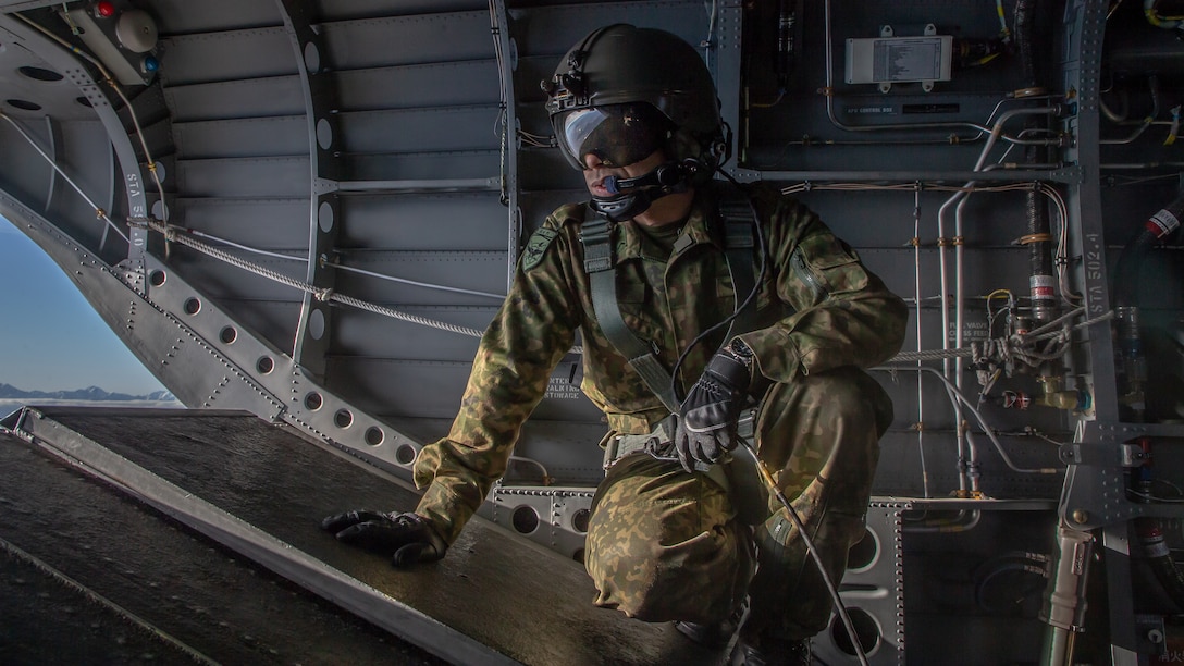 A member of the Japan Ground Self Defense Force looks out the back of a CH-47JA Chinook helicopter during exercise Forest Light Eastern Army at Camp Soumagahara, Gunma Prefecture, Japan, Dec. 9.