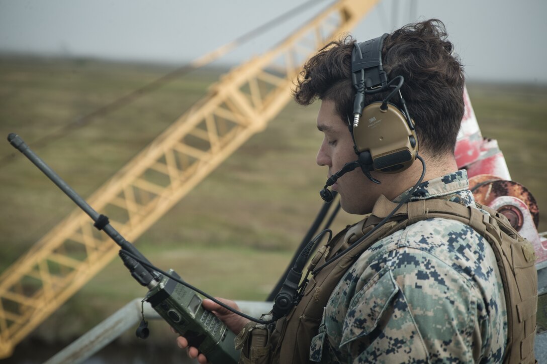 U.S. Marine Lance Cpl. Peter Tubiolo, a radio operator with Second Air-Naval Gunfire Liaison Company (2D ANGLICO) conducts a radio check during a Joint Terminal Attack Controller training exercise at Bombing Target 11, at Piney Island, North Carolina, Oct. 20, 2020.