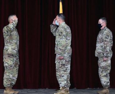 (From left) Incoming Command Sgt. Maj. Jose M. Salas, 5th Brigade, U.S. Army Cadet Command, salutes Col. Mark A. Olsen, 5th Brigade commander, as outgoing Command Sgt. Maj. George B. Bunn looks on during achange of responsibility ceremony at Joint Base San Antonio-Fort Sam Houston Dec. 18.